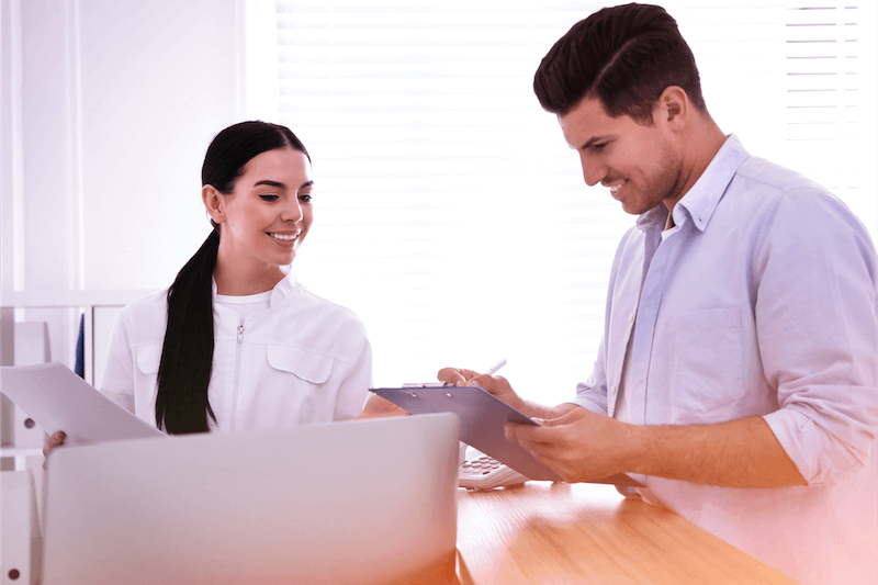 Man and woman lookg at paper work happy.